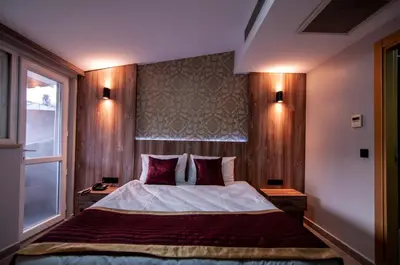 a bedroom with a large bed and a window at Vali Konak Hotel Nişantaşı in Istanbul