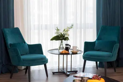 two chairs and a table with a vase of flowers at Wish More Hotel Istanbul in Istanbul