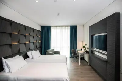 a hotel room with two beds and a television at Wish More Hotel Istanbul in Istanbul