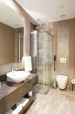 a bathroom with a sink and a shower and a toilet at Park Dedeman Bostanci Hotel in Istanbul