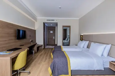 a hotel room with a bed and a desk at Nearport Hotel Sabiha Gokcen Airport in Istanbul