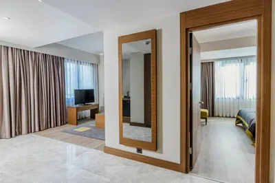 a room with a mirror and a bedroom at Nearport Hotel Sabiha Gokcen Airport in Istanbul