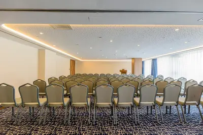 a conference room with a row of chairs and a podium at Nearport Hotel Sabiha Gokcen Airport in Istanbul