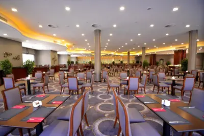 a banquet hall with tables and chairs in a restaurant at Grand Cevahir Hotel Convention Center in Istanbul