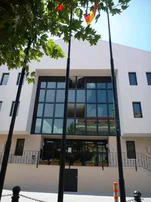 a building with windows and trees in front of it at Montania Town Hotel Mudanya in Mudanya