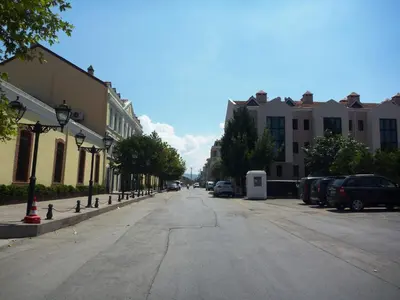 an empty street with parked cars and buildings at Montania Town Hotel Mudanya in Mudanya