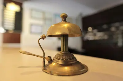 a gold bell sitting on top of a table at Montania Town Hotel Mudanya in Mudanya