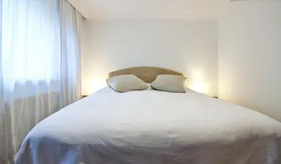 a bedroom with a white bed with two pillows at Inin Bebek in Istanbul