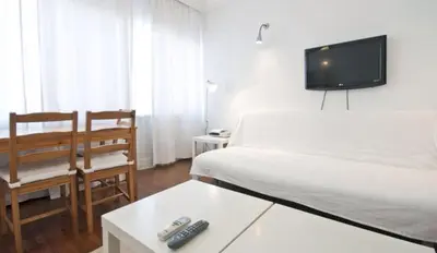 a bedroom with a bed and a tv on the wall at Inin Bebek in Istanbul