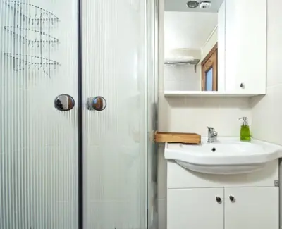 a white bathroom with a sink and a shower at Inin Bebek in Istanbul