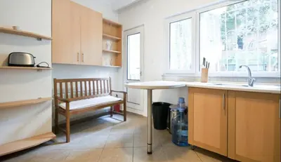a kitchen with a bench and a table and a sink at Inin Bebek in Istanbul