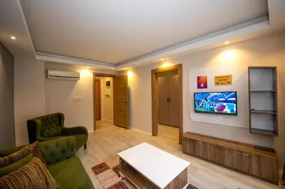 a living room with a couch and a tv on a wall at Marida Suit - Istanbul Taksim in Istanbul