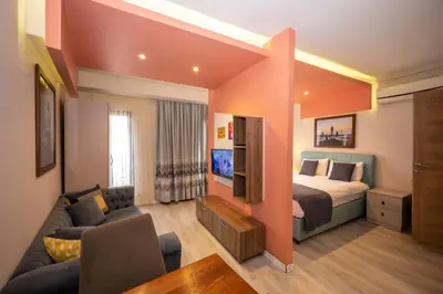 a bedroom with a bed and a couch and a tv at Marida Suit - Istanbul Taksim in Istanbul