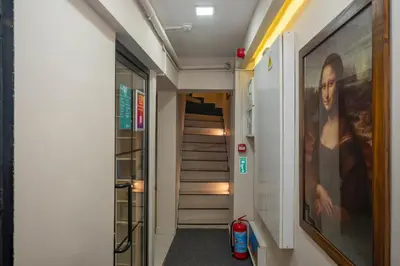 a hallway with stairs and a painting of a woman at Marida Suit - Istanbul Taksim in Istanbul