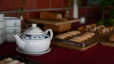 a table with a tea pot and a tray of cookies at Kadıköy Rıhtım Hotel in Istanbul