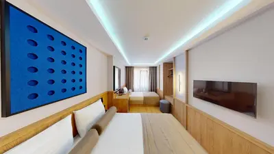 a hotel room with a bed and a flat screen tv at Istanbul River Hotel in Istanbul