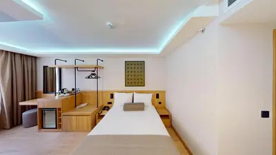 a bedroom with a large bed and a desk at Istanbul River Hotel in Istanbul