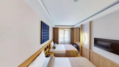 a hotel room with two beds and a flat screen tv at Istanbul River Hotel in Istanbul