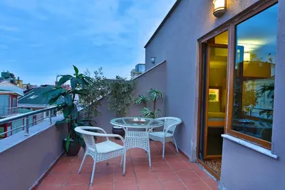 a patio with a table and chairs on a balcony at Budo Hotel in Istanbul