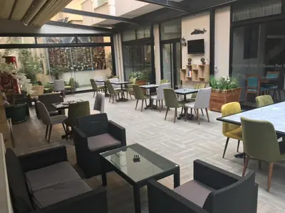 a restaurant with tables and chairs and windows at Niconya Port Suite&Hotel in Istanbul