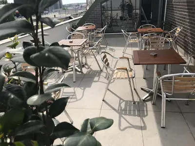 an outdoor patio with tables and chairs and a plant at Niconya Port Suite&Hotel in Istanbul