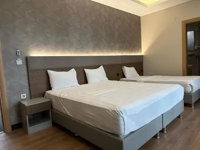 two beds in a hotel room with two bedsvisor at Niconya Port Suite&Hotel in Istanbul