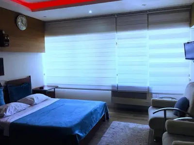 a bedroom with a bed and a large window at Masal Otel in Kocaeli