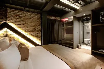 a bedroom with a bed and a brick wall at Cityloft 81 in Istanbul