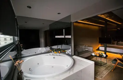 a large bathroom with two tubs and a large mirror at Cityloft 81 in Istanbul
