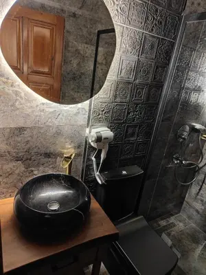 a bathroom with a black sink and a mirror at Star Hotel in Istanbul
