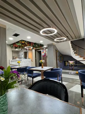 a restaurant with blue chairs and a table and stairs at Best Nobel Hotel in Istanbul