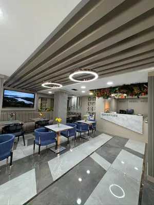 a lobby with blue chairs and tables in a building at Best Nobel Hotel in Istanbul