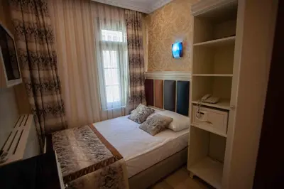 a small bedroom with a bed and a window at Best Nobel Hotel in Istanbul