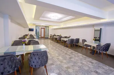 a large room with tables and chairs and a room with at Sim Hotel Istanbul Old City in Istanbul