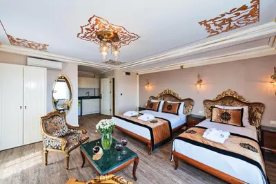 a hotel room with two beds and a table at The Byzantium Suites Hotel & Spa in Istanbul