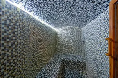 a bathroom with a shower with a tiled wall at The Byzantium Suites Hotel & Spa in Istanbul