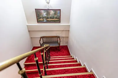 a stairway with a chair and a red carpet at Elasophia Hotel in Istanbul