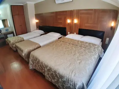 two beds in a hotel room with wood paneling at Elasophia Hotel in Istanbul