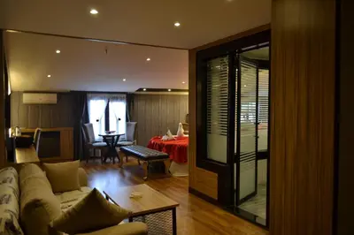 a living room with a couch and a dining room at Gumus Palace Suites in Istanbul