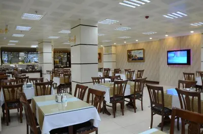 a dining room with tables and chairs in a restaurant at Gumus Palace Suites in Istanbul
