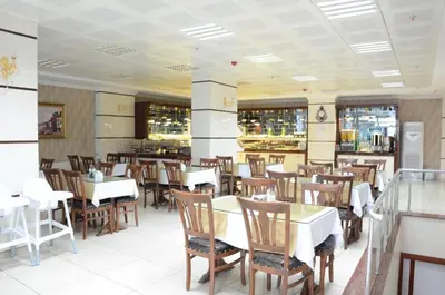 a dining room with tables and chairs in a restaurant at Gumus Palace Suites in Istanbul