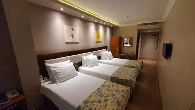 a hotel room with two beds and a television at Asur Hotel in Istanbul