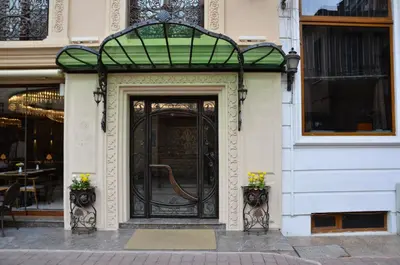 a door to a building with a green glass at Asur Hotel in Istanbul