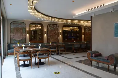 a restaurant with tables and chairs and a chandelier at Asur Hotel in Istanbul