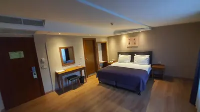a hotel room with a bed and a mirror at Asur Hotel in Istanbul