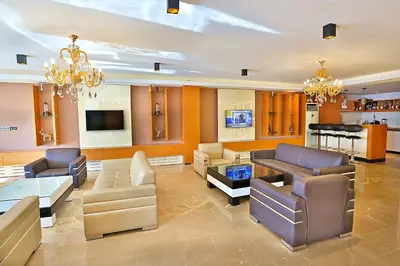 a large living room with couches and a tv at Grand Sagcanlar Hotel in Istanbul