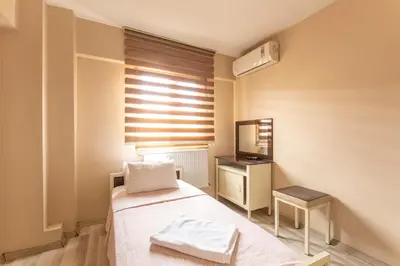 a small room with a bed and a mirror at Beyoglu Huzur Hotel in Istanbul