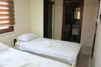 two beds in a room with a mirror at Beyoglu Huzur Hotel in Istanbul