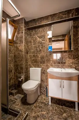 a bathroom with a toilet and a sink at Beyoglu Huzur Hotel in Istanbul