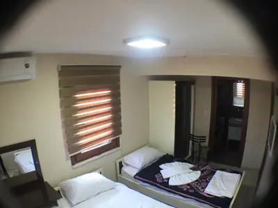 a small bedroom with two beds and a mirror at Beyoglu Huzur Hotel in Istanbul
